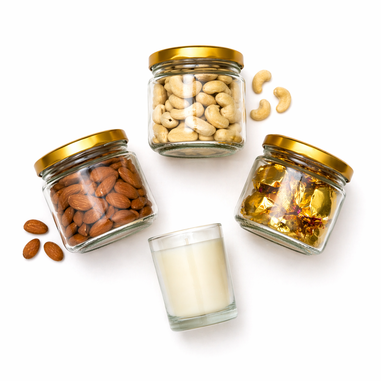 Three glass jars with gold lids containing almonds, cashews, and a scented candle