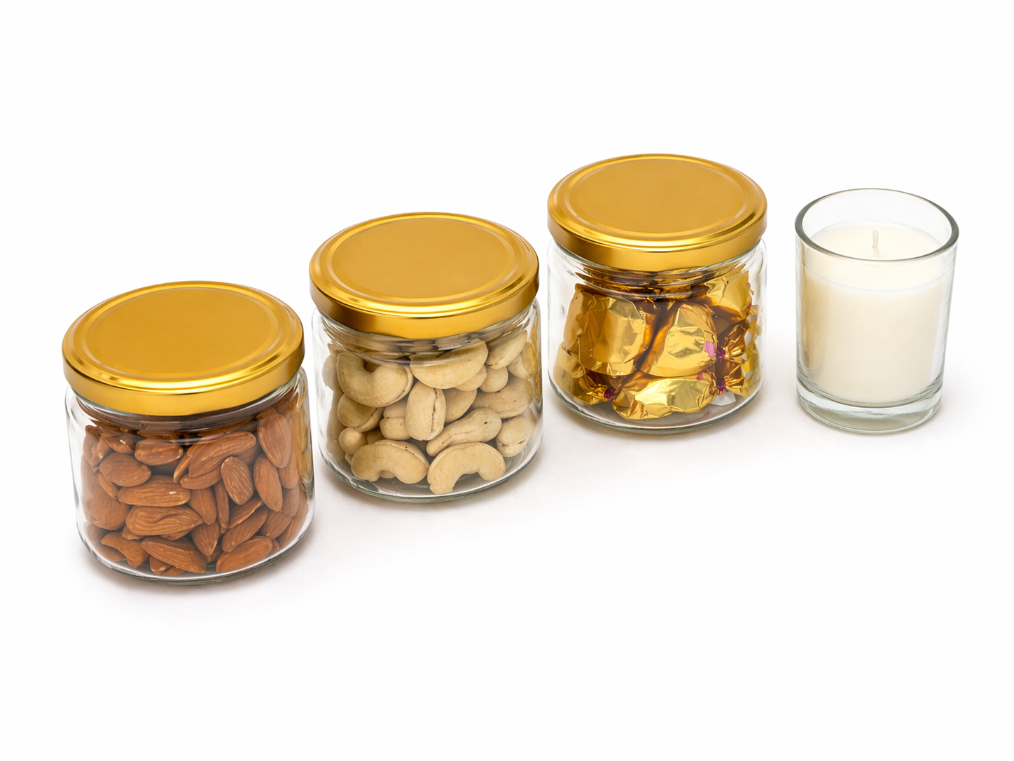 Four glass jars with gold lids containing various nuts and scented candle 